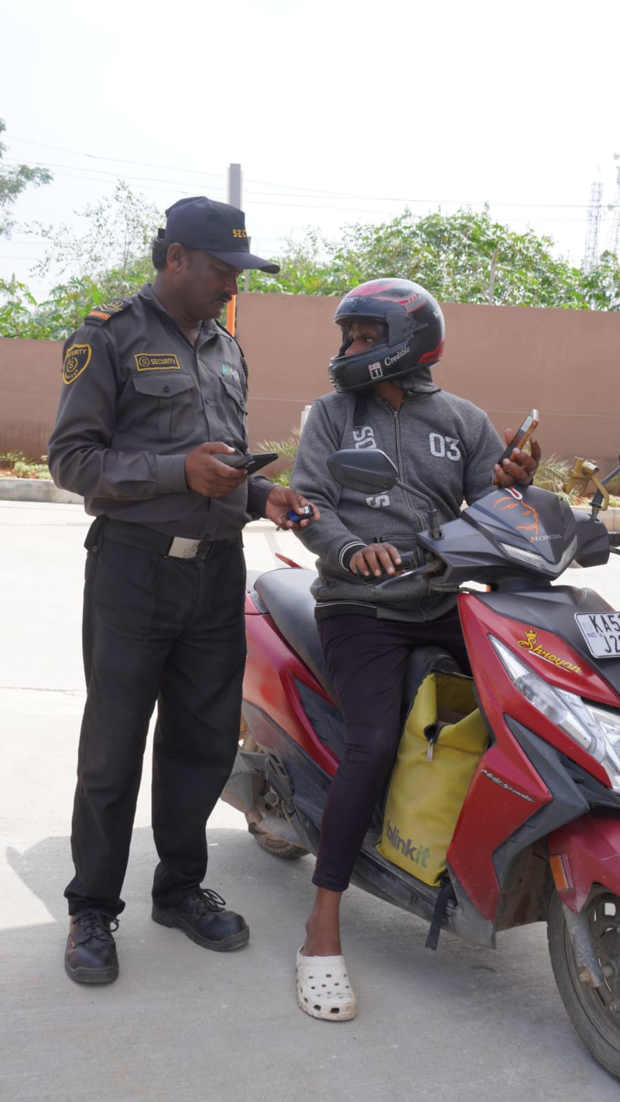 Two-wheeler entry check &mdash; Rider credentials confirmed before the barrier lifts.