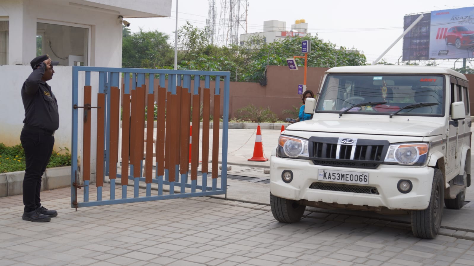 Gate access control &mdash; Vehicle clearance and salute protocol at the entry barrier.