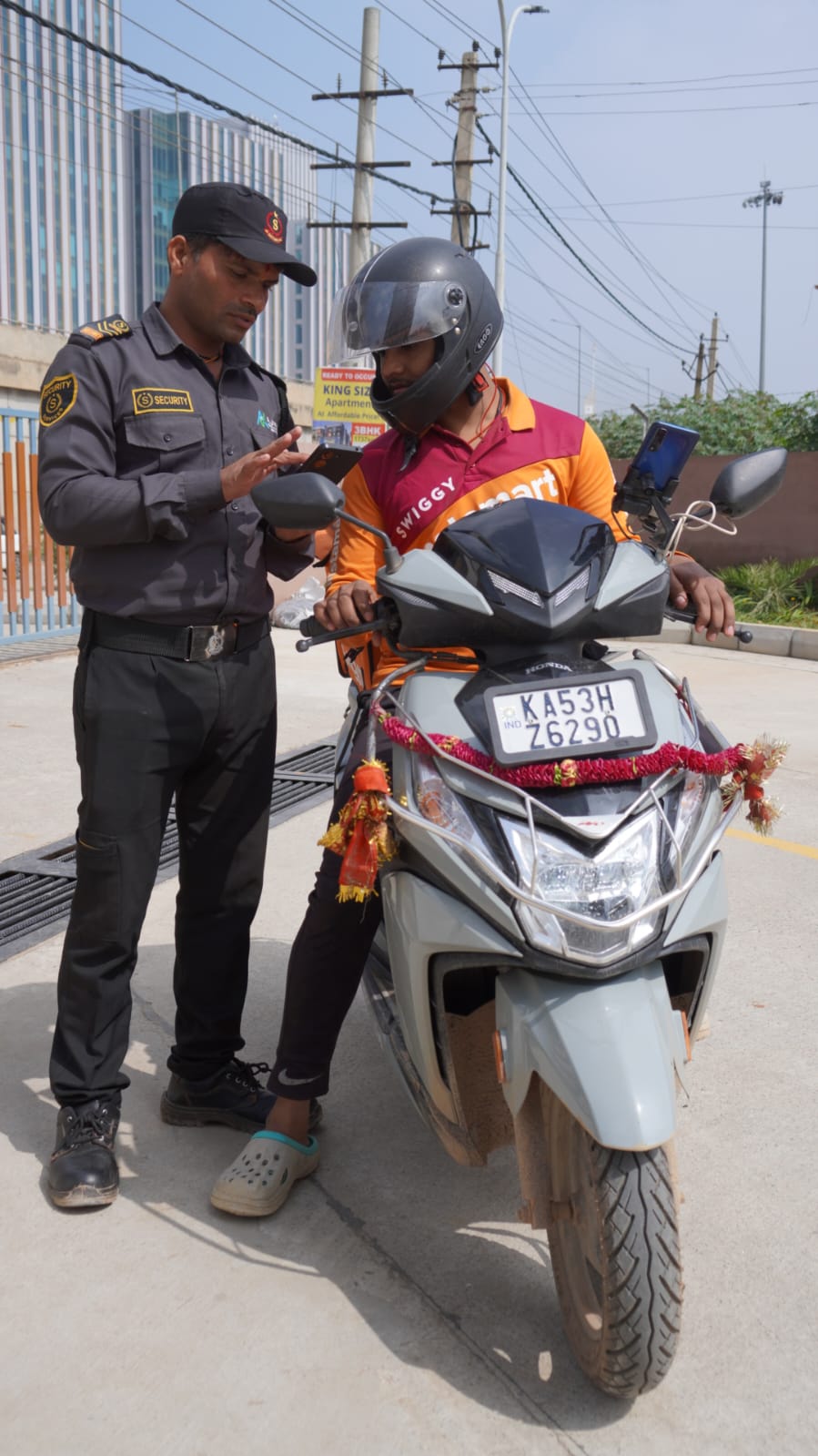 Digital entry logging &mdash; Delivery riders logged on a handheld before entry is cleared.